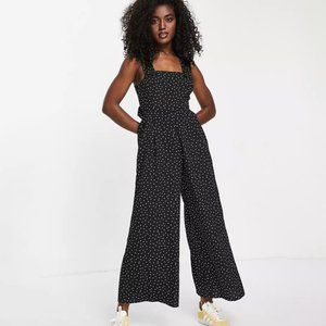 ASOS DESIGN pinafore frill cross back jumpsuit in polka dot print